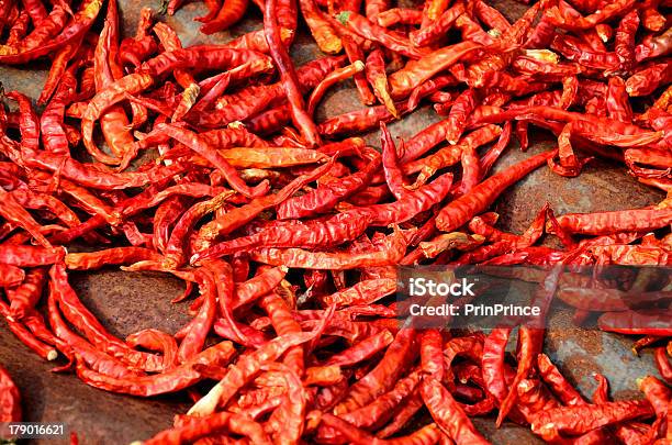 Red Chilli Pods Are Lying For Drying In Strong Sunlight Stock Photo - Download Image Now
