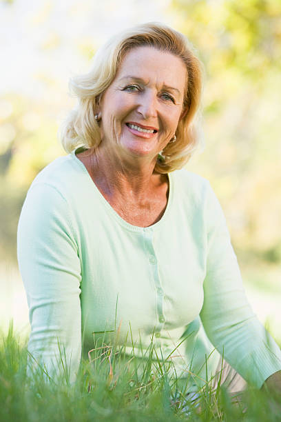 istock Woman sitting outdoors smiling 179017084