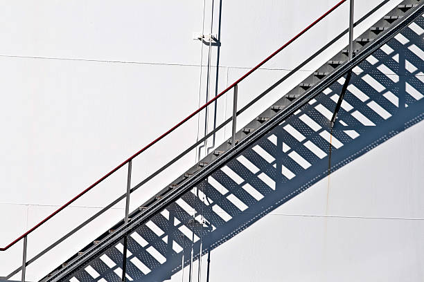 istock white tanks in tank farm with staircase 179018352