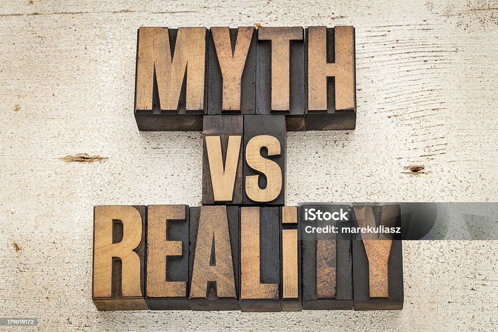 myth versus reality myth versus reality - concept  in vintage letterpress wood type on a grunge painted barn wood background Mythology Stock Photo