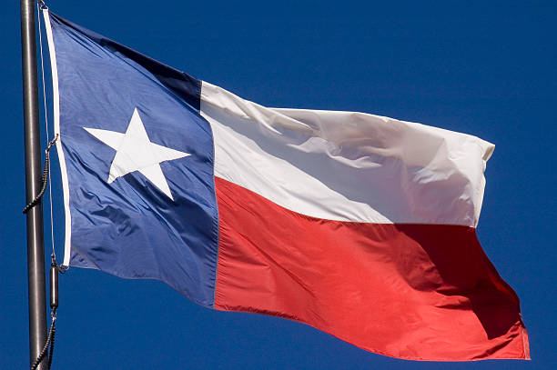 The state of Texas lone star flag flying proudly in the air stock photo