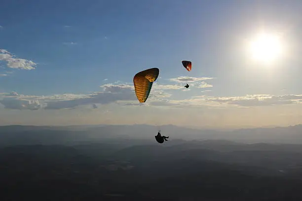 Paraglider flying in the sea of the mountains of general mines