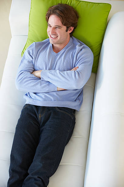 istock Overhead View Of Man Relaxing On Sofa 179020132