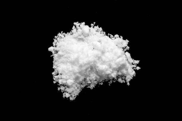 istock White snow isolated on black background close up 1790205147