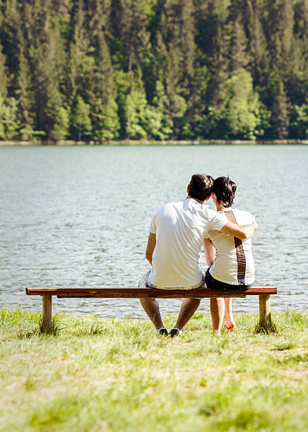 istock Young lovers sitting on wooden bench 179020564