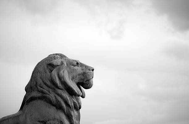 Lion Statue against a cloudy sky in Madrid