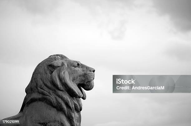 Lion Statue Against A Cloudy Sky In Madrid Stock Photo - Download Image Now - Lion - Feline, Statue, Sculpture