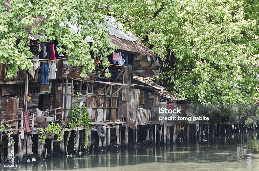 Slum on dirty canal Slum on dirty canal in Bangkok, Thailand Architecture Stock Photo