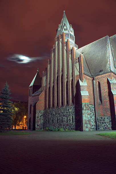 gothic church with tower by night in Poznan, Poland