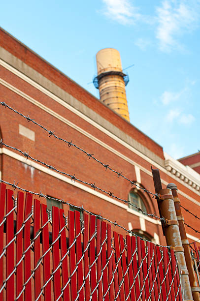 istock Factory chimney and fence with barbed wire 179021477