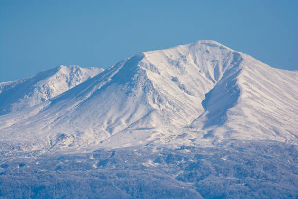 istock Snow-capped volcano peak on a sunny winter day 1790221275