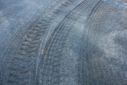 Fresh black tyre traces on asphalt.