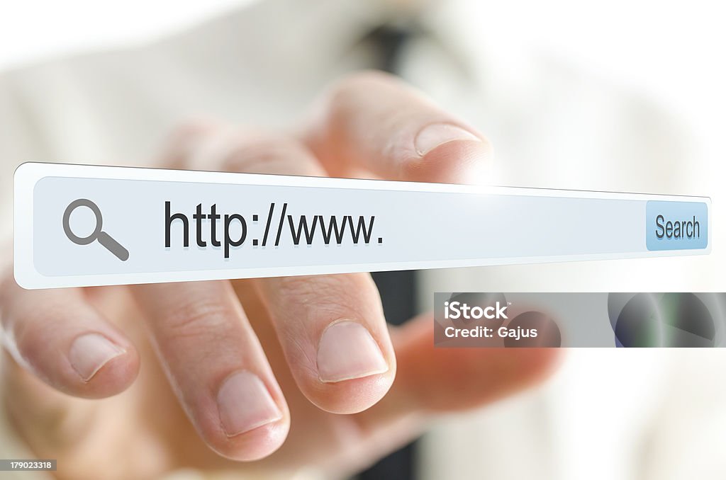 Hand touching the Internet search bar on a virtual screen http://www. written in search bar on virtual screen. Accessibility Stock Photo