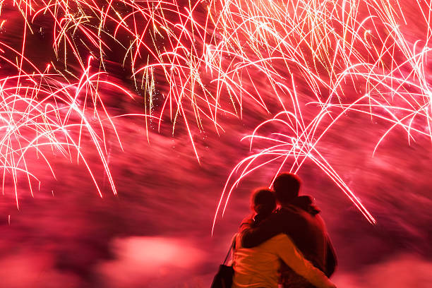 Big fireworks with young romantic couple in love