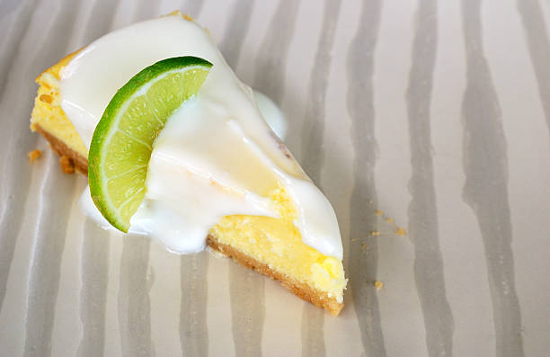 istock Slice of lime cheesecake on the vertical pattern plate 179023914