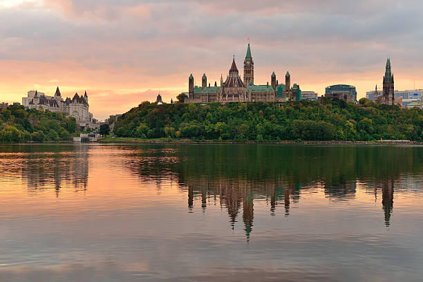 Ottawa morning Ottawa city skyline at sunrise in the morning over river with urban historical buildings and colorful cloud parliament hill ottawa stock pictures, royalty-free photos & images