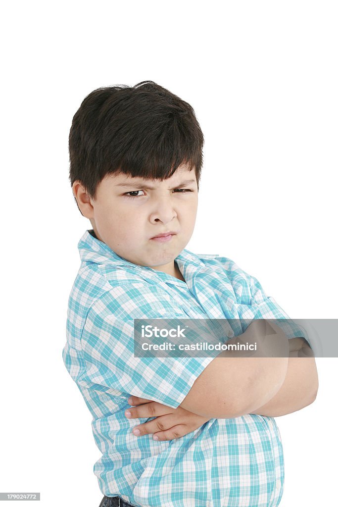 serious little boy with hands folded standing serious little boy with hands folded standing isolated on white background Anger Stock Photo