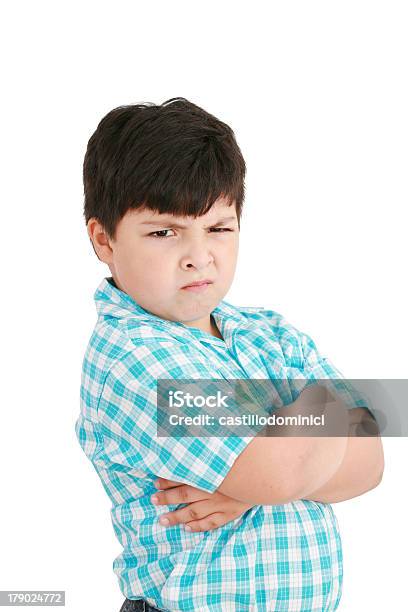 Serious Little Boy With Hands Folded Standing Stock Photo - Download Image Now - Anger, Displeased, Pre-Adolescent Child
