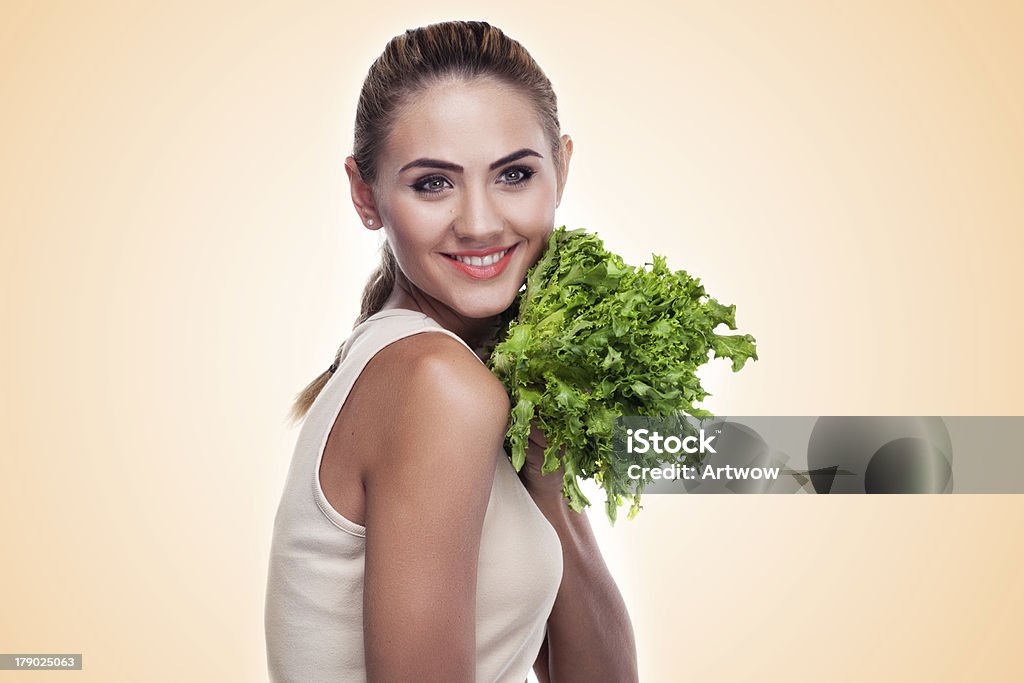 woman with bundle herbs (salad). Concept vegetarian dieting - he Close-up portrait of happy young woman with bundle herbs (salad) in hands on white background. Concept vegetarian dieting - healthy food Adult Stock Photo