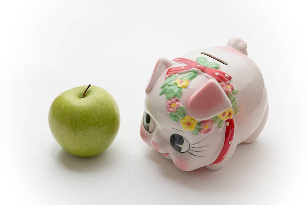 istock one green apple beside the saving pot 179025138