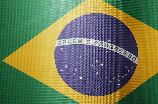 Brazil flag in green yellow and blue close-up, highlighting the pride of Brazilians in vivid fabric.