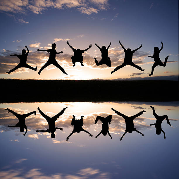 istock silhouette of kids jumping in sunset 179025544