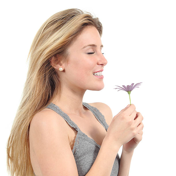 istock Beautiful woman smelling a lilac daisy 179026008