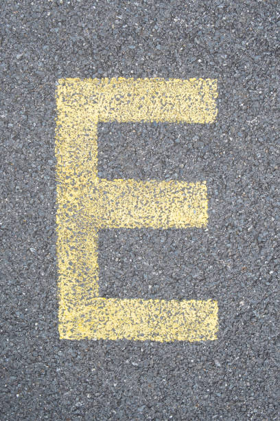 the Letter E are drawn with color paint on asphalt. a children's playground designed a creative display of the alphabet educational element learning space.