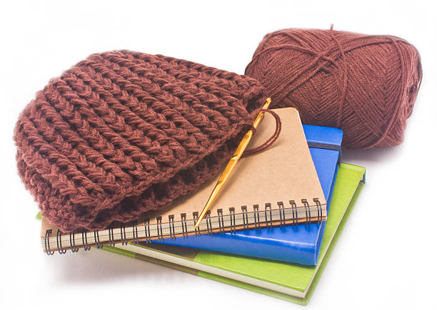 istock Brown crochet hat with golden hook, yarns and books. 179027757