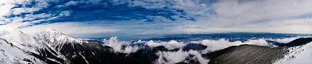 A panoramic view from Fagaras mountain, with clouds above the cities