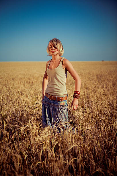 istock young woman on wheat field 179029163