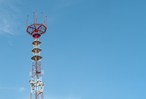 Telecommunication TV broadcast tower, sky background