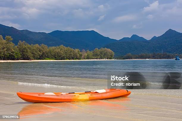 Orange Kayak On The Beach With Blue Mountain Stock Photo - Download Image Now - Bay of Water, Beach, Beauty