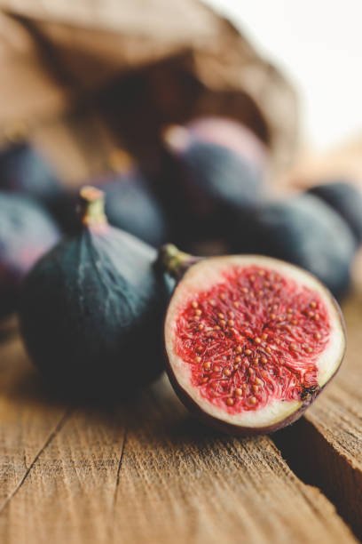 istock A few figs in a bowl on an old wooden background. 1790300409