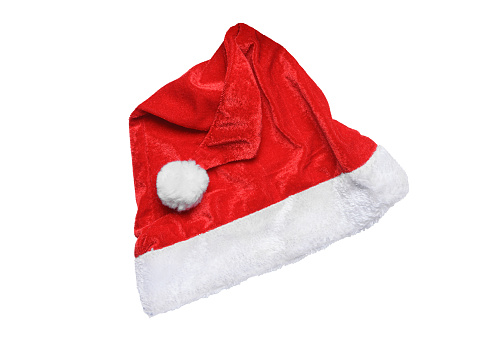 Santa Claus hat isolated on white background. Design element, traditional Christmas symbol. Red velour Santa hat, top view, flat lay.