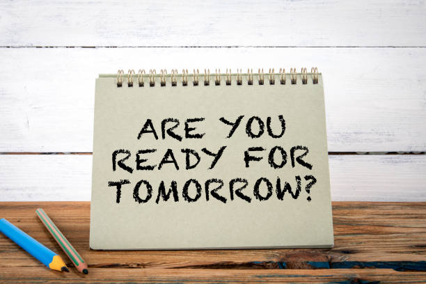 istock Are You Ready For Tomorrow. Green notepad on wooden texture table and white background 1790302069
