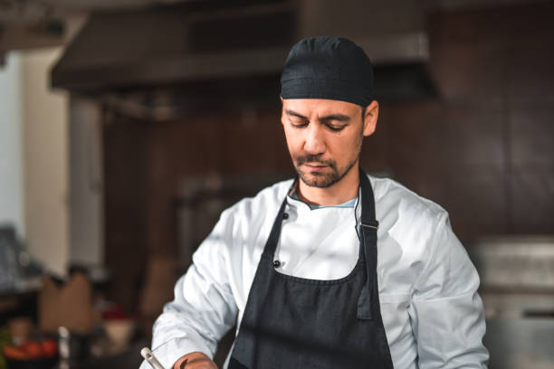 istock Focused Male Chef with a Beard Cooking 1790306469