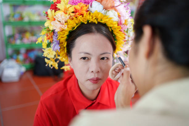 Charming girl with an angelic face and a beautiful accessories flower big white purple bow. Pretty young lady beautiful lips smile perfect shape brown eyebrows eyes, make up skin texture shadows. Happiness