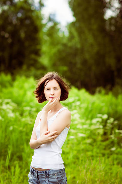 istock Adorable young woman in summer forest, field 179032164