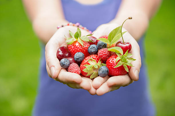 istock girl holding fruits 179032621