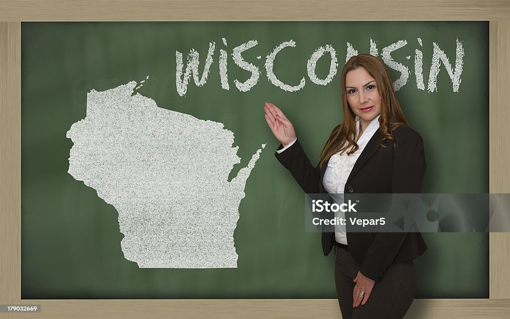 Teacher showing map of wisconsin on blackboard Successful, beautiful and confident young woman showing map of wisconsin on blackboard for presentation, marketing research and tourist advertising Adult Stock Photo