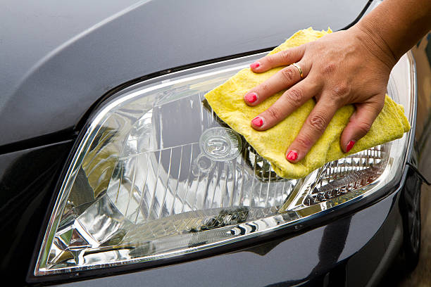 Hand wiping car headlight clean  Hand with a wipe the car polishing toilet brush photos stock pictures, royalty-free photos & images
