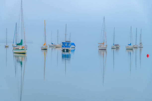 istock Fog, sunrise and boats on the bay 1790340272