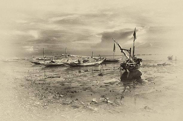 istock Wrecked boats at receding shore 179034084