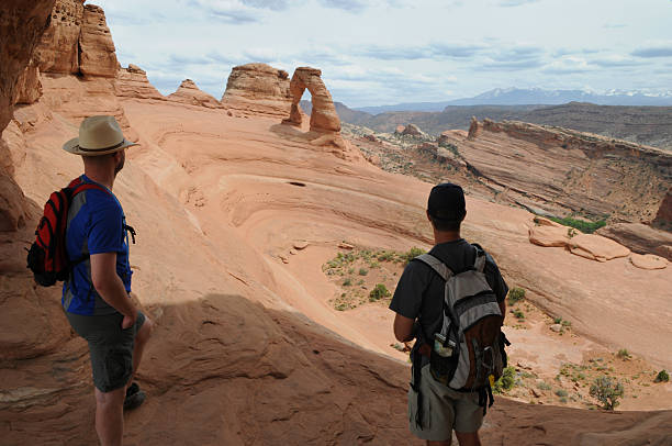 istock Two Hikers at Delicate Arch 179034630