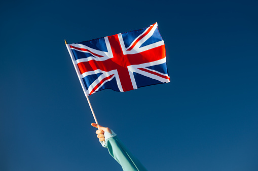 Wooden gavel and British flag.