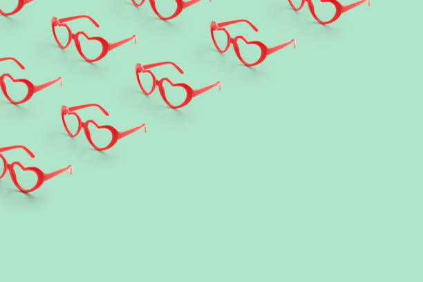istock Pattern made with red heart shaped sunglasses on pastel color background 1790355495