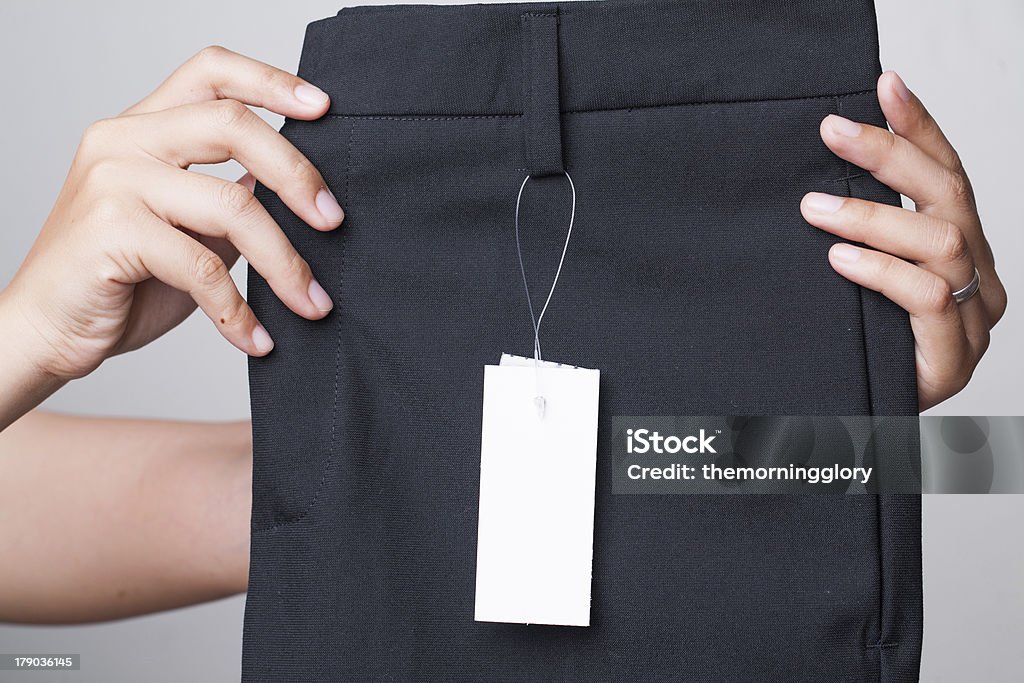 hand catch pants close up hand catch pants close up with white label Adult Stock Photo