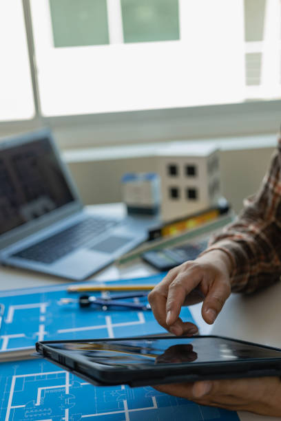 istock architects hands drawing of modern house with material sample on creative desk Architect Engineer Design Working on Blueprint Planning Concept. Construction Concept 1790381625