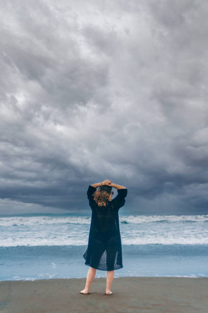 istock girl on her back on the beach. Copy space 1790398758